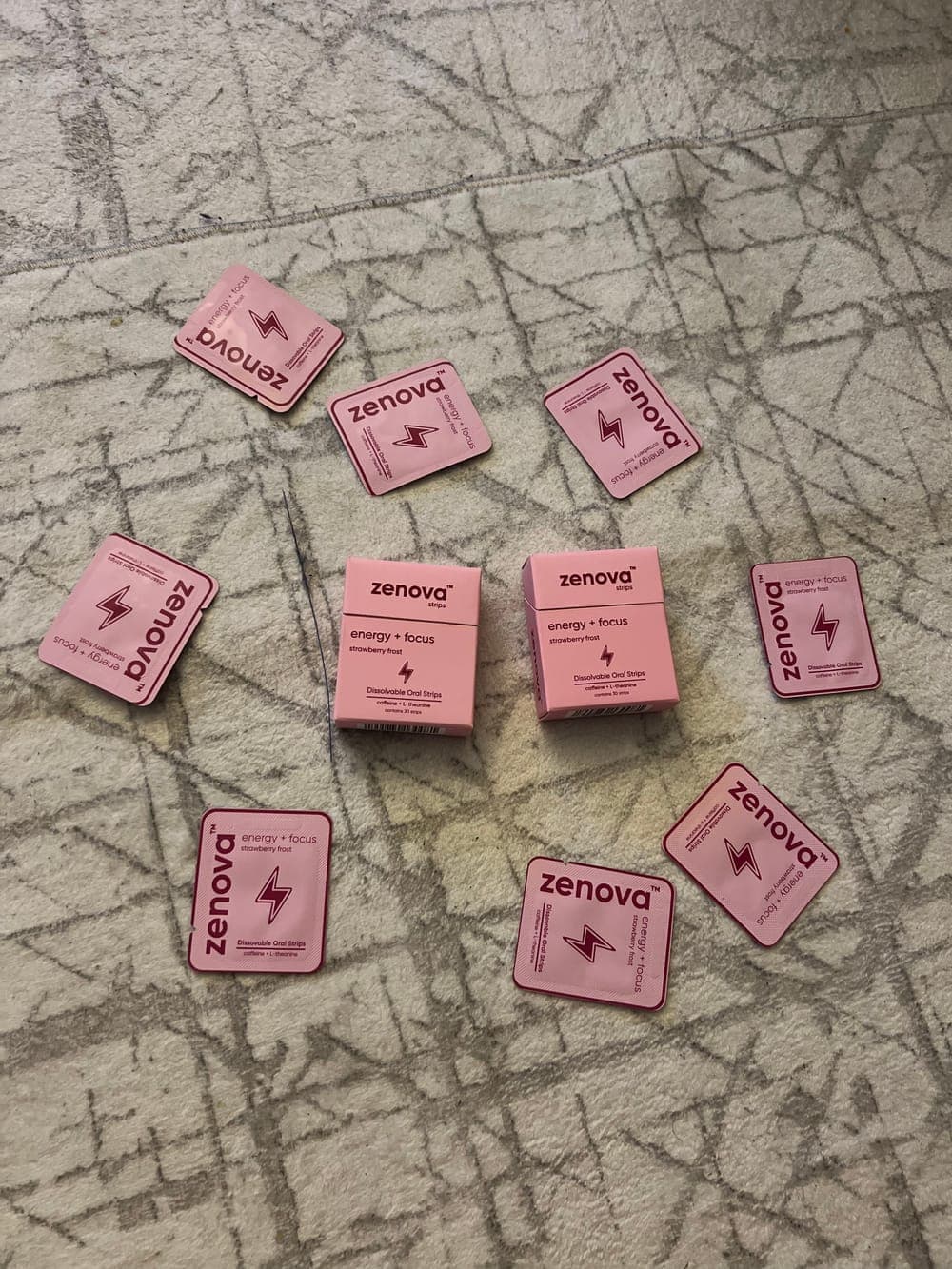 Two Zenova boxes and loose strips on a rug